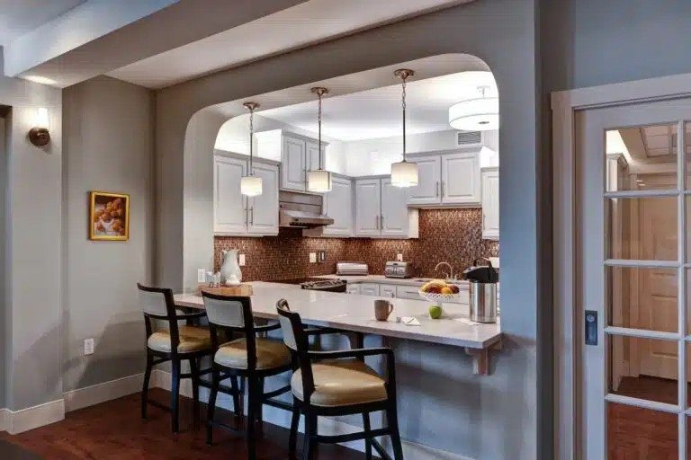 A kitchen with a table and chairs  at The Piper, Kansas City, KS.